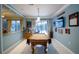 Bright game room with a pool table, bar pass through, and lots of natural light at 8679 Burning Tree Cir, Seminole, FL 33777