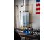 Garage space equipped with a tankless water heater and workout equipment, blending utility with fitness at 8679 Burning Tree Cir, Seminole, FL 33777