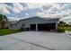Spacious three-car garage, providing ample parking and storage, enhances the home's functionality and curb appeal at 8679 Burning Tree Cir, Seminole, FL 33777