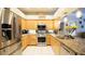 Beautiful kitchen boasts a stainless steel refrigerator, stainless appliances, and granite countertops at 8679 Burning Tree Cir, Seminole, FL 33777