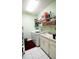Functional laundry room features a washer, dryer, sink, countertops and shelving for organized storage and convenience at 8679 Burning Tree Cir, Seminole, FL 33777