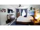 Comfortable main bedroom with a ceiling fan, lots of natural light, and white plank accent wall at 8679 Burning Tree Cir, Seminole, FL 33777