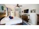 Comfortable main bedroom with a ceiling fan, lots of natural light, and white plank accent wall at 8679 Burning Tree Cir, Seminole, FL 33777