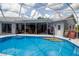 Inviting screened-in pool with an outdoor seating area provides a relaxing atmosphere for entertainment and leisure at 8679 Burning Tree Cir, Seminole, FL 33777