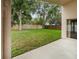 A spacious backyard featuring a grassy lawn, privacy fence, and mature shade trees at 9008 Egret Cove Cir, Riverview, FL 33578