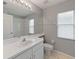 Bathroom features a single sink vanity, tile floors, and a large mirror for a clean aesthetic at 9008 Egret Cove Cir, Riverview, FL 33578