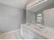 Bathroom featuring a large mirror, dual sinks, a white vanity and floors at 9008 Egret Cove Cir, Riverview, FL 33578