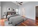 A serene bedroom features wood floors, a ceiling fan, neutral walls and a gray upholstered bed at 9008 Egret Cove Cir, Riverview, FL 33578