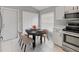 Bright dining nook with tiled floor, modern table set, and ample storage with a kitchen view at 9008 Egret Cove Cir, Riverview, FL 33578