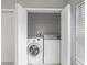 Laundry closet with a stacked washer and dryer offers convenience at 9008 Egret Cove Cir, Riverview, FL 33578