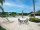 Community pool area with patio furniture, palm trees, and blue skies at 9008 Egret Cove Cir, Riverview, FL 33578