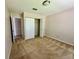 Spacious bedroom with neutral paint and carpet with a walk-in closet at 907 San Carlos Ne Ave, St Petersburg, FL 33702