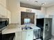 Open kitchen with a view to the dining area and a stainless steel refrigerator at 907 San Carlos Ne Ave, St Petersburg, FL 33702