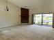 Bright living room with a cozy fireplace and a large sliding glass door overlooking the serene lake at 907 San Carlos Ne Ave, St Petersburg, FL 33702