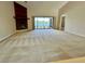 Spacious living room featuring a brick fireplace and sliding glass doors with a view of the lake at 907 San Carlos Ne Ave, St Petersburg, FL 33702