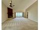 Spacious living room featuring a brick fireplace and sliding glass doors with a view of the lake at 907 San Carlos Ne Ave, St Petersburg, FL 33702