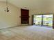 Spacious living room with a fireplace, lake views, and sliding glass doors to the lanai at 907 San Carlos Ne Ave, St Petersburg, FL 33702