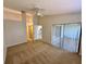 Main bedroom featuring a fan, a sliding door to the patio and a view of the kitchen at 907 San Carlos Ne Ave, St Petersburg, FL 33702