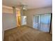 Main bedroom featuring a fan, a sliding door to the patio and a view of the kitchen at 907 San Carlos Ne Ave, St Petersburg, FL 33702