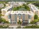 Aerial view of condo community surrounding a pond, showcasing community's layout, landscaping, and building styles at 960 Starkey Rd # 2103, Largo, FL 33771