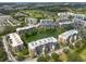 Aerial view of condo community with pond, greenery, manicured lawns, and golf course views, presenting a desirable location at 960 Starkey Rd # 2103, Largo, FL 33771