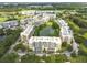 Drone view of the complex surrounding a pond and manicured landscaping at 960 Starkey Rd # 2103, Largo, FL 33771