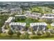 Aerial of a condo community with manicured landscaping, water features, and views of nearby golf course at 960 Starkey Rd # 2103, Largo, FL 33771