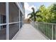 Extended screened balcony with view of the building's exterior and lush landscaping at 960 Starkey Rd # 2103, Largo, FL 33771