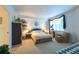 Cozy bedroom featuring an exercise bike, neutral walls, and large window for natural light at 960 Starkey Rd # 2103, Largo, FL 33771