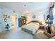 Bright bedroom featuring neutral walls, patterned furniture and a large window for natural light at 960 Starkey Rd # 2103, Largo, FL 33771