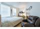 Inviting bedroom with musical decor, a comfortable armchair, and a large window for natural light at 960 Starkey Rd # 2103, Largo, FL 33771