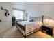 Well-lit bedroom with neutral carpet, a metal bed frame, and ample natural light from the window at 960 Starkey Rd # 2103, Largo, FL 33771
