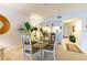 Bright dining area next to the kitchen, featuring a glass table and views of the living space at 960 Starkey Rd # 2103, Largo, FL 33771