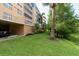 Well-maintained lawn area with mature landscaping and building exterior providing serene outdoor space at 960 Starkey Rd # 2103, Largo, FL 33771