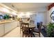 A modern kitchen with white cabinets, with an adjacent dining area at 960 Starkey Rd # 2103, Largo, FL 33771