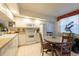 Eat-in kitchen features white cabinetry, and appliances at 960 Starkey Rd # 2103, Largo, FL 33771