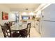Well-lit kitchen with white cabinetry, tile flooring, and a dining area with round granite table at 960 Starkey Rd # 2103, Largo, FL 33771
