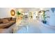 Bright living room with views of the dining area, with decorative plants and glass coffee table at 960 Starkey Rd # 2103, Largo, FL 33771