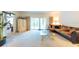 Inviting living room featuring a comfortable sofa, glass coffee table, and sliding glass doors at 960 Starkey Rd # 2103, Largo, FL 33771