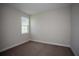 Bright bedroom featuring a single window and neutral carpeting at 9921 Surrey Rose Dr, San Antonio, FL 33576