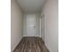 Inviting entryway featuring a light and bright space, beautiful wood-look flooring, and a white front door at 9921 Surrey Rose Dr, San Antonio, FL 33576