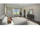 Cozy main bedroom featuring natural light from dual windows, carpeted floors, and an adjacent bathroom at 9921 Surrey Rose Dr, San Antonio, FL 33576