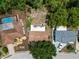 Overhead aerial shot of property showing the backyard, surrounding houses, and neighborhood layout at 9927 Woodridge Ct, Port Richey, FL 34668