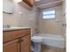 Clean bathroom with a shower and tub combination, tiled walls, and a wood vanity at 9927 Woodridge Ct, Port Richey, FL 34668