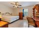 Bedroom featuring tile floors, a ceiling fan, natural light, and traditional furniture pieces at 9927 Woodridge Ct, Port Richey, FL 34668
