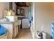 Utility and laundry room with sink, storage, water heater, and washing machine at 9927 Woodridge Ct, Port Richey, FL 34668