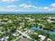 Drone shot showcasing the property, the lake and the coastline in the distance at 996 56Th S Ave, St Petersburg, FL 33705