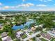 Aerial view of the property showcasing its location on a lake, surrounded by lush greenery at 996 56Th S Ave, St Petersburg, FL 33705
