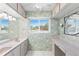 Bathroom with a double sink, vanity and floral wallpaper at 996 56Th S Ave, St Petersburg, FL 33705