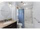 Clean bathroom with a granite countertop, updated shower, and a large mirror at 996 56Th S Ave, St Petersburg, FL 33705